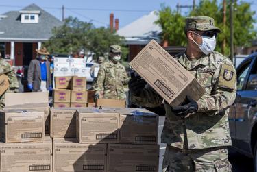 Members of the National Guard hand out food at the Kelly Memorial Food Pantry in Central El Paso during the Coronavirus pandemic on Tuesday.