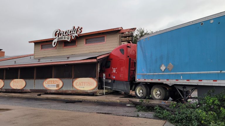 Driver unhurt after Amazon truck crashes into restaurant, breaks open