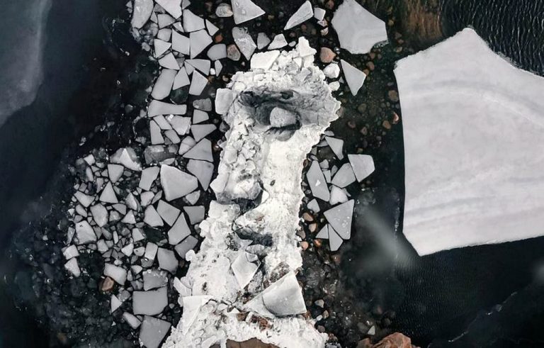 Artist Paints Charcoal Portraits on Giant Floating Blocks of Ice in Baltic Sea – LOOK