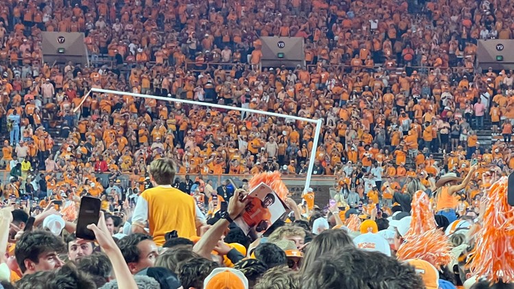 Tennessee fans celebrate historic win over Alabama by rushing the field, tearing down goalposts