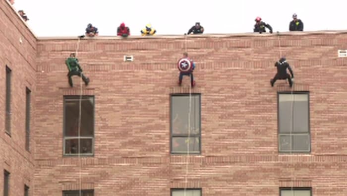 Halloween Tradition: Superheroes rappel down hospital to visit children